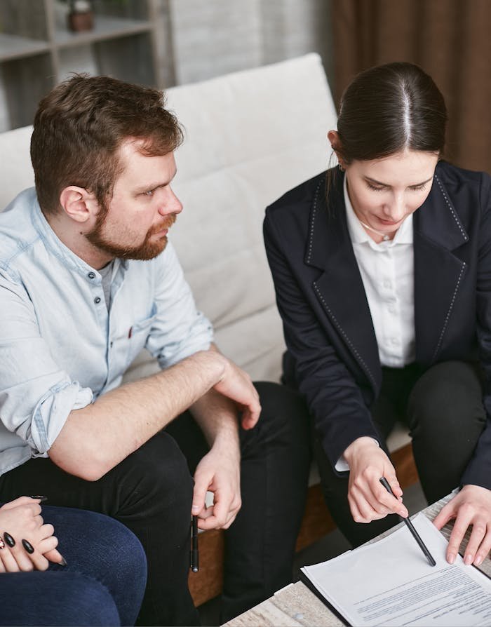 home-services-01 Business professionals in a meeting reviewing significant documents in an office setting.